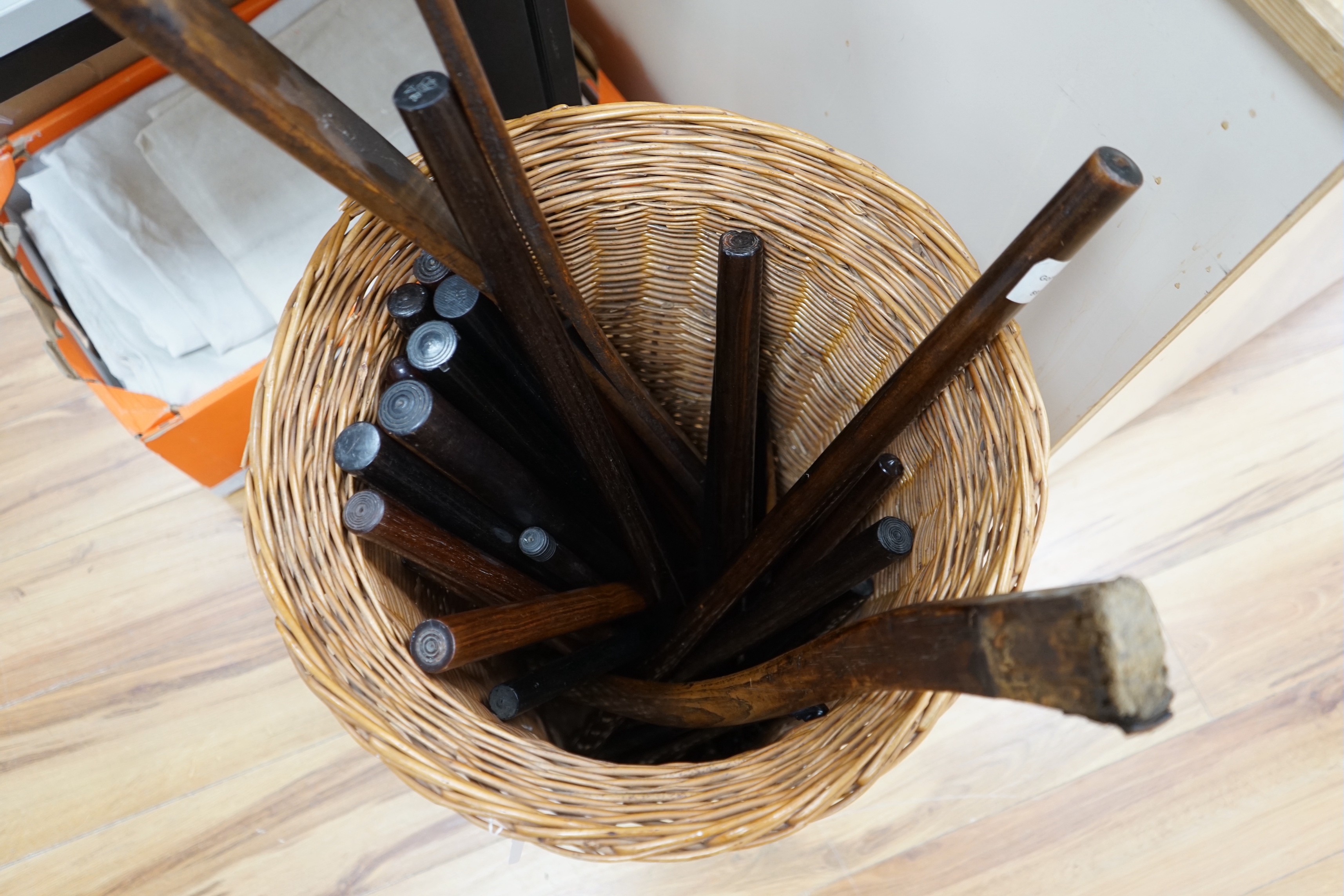 A large mixed collection of wooden canes and measuring sticks etc.